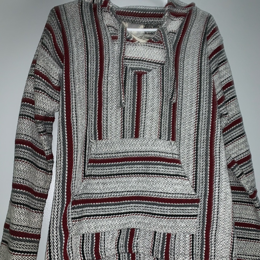 Grey, green, red, and black drug rug